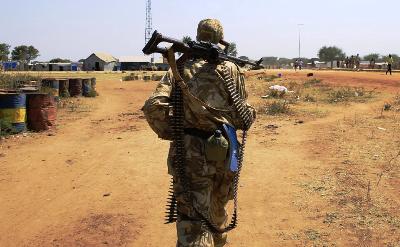 A South Sudan army soldier carries his weapon as he patrols a road near Bor Airport, 180 km (108 miles) northwest from capital Juba December 25, 2013 (Reuters/James Akena)