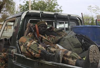 A Sudan People's Liberation Army (SPLA) soldier rests on the back of a truck in Malakal on 21 January 2014 (Photo: Reuters/Andreea Campeanu)