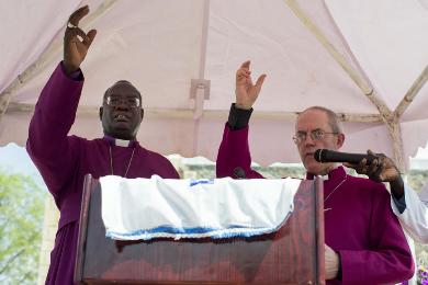 Archbishop of South Sudan Daniel Deng Bul, left, and the Archbishop of Canterbury Justin Welby, right, say a prayer outside a chuch in Juba, South Sudan Thursday, Jan. 30, 2014. (Photo AP/Mackenzie Knowles-Coursin)