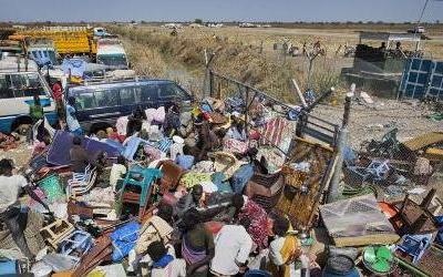 IDPs stack their belongings up outside the gate of the UNMISS compound, after government forces on Friday retook the provincial capital of Bentiu, in Unity State, Sunday, Jan 12, 2014 (Photo AP/Mackenzie Knowles-Coursin)
