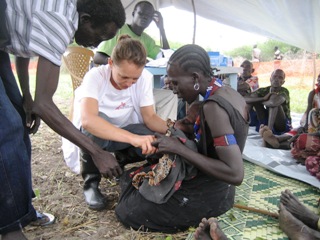 A Belgian nurse examines a baby during an MSF mobile clinic in Dorain, Jonglei (MSF courtesy photo)