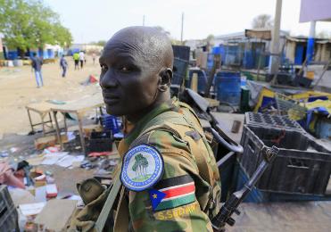 South Sudanese army soldier stands near belongings thrown on the street of Malakal town,  Dece 30, 2013 after retaking the town from rebel fighters. (Photo Reuters/James Akena)