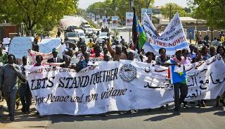 South Sudanese people take part in a peace march organised by civil society groups in the capital Juba, Wednesday, Jan. 8, 2014 (AP/Ali Ngethi)