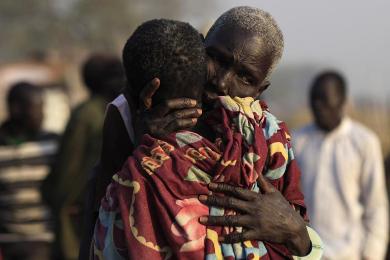 Women displaced by the fighting in Bor county hug each other in the port in Minkaman, in Awerial county, Lakes state, in South Sudan, January 15, 2014. (Photo Reuters/Andreea Campeanu)