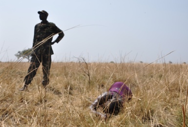 A South Sudanese soldier stands near the body of a woman killed in an attack on Jonglei state’s Kolnyang payam on Wednesday in which 28 people died (ST)