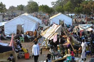 People gather at a makeshift IDP camp at the UN compound in Juba on December 22, 2013 where South Sudanese continue to flock as fears of a resumption of fighting in the capital fester. (AFP/Tony KARUMBA)