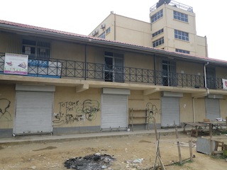 Ruben Kok apartment in Bor with gravitee and writing on it. Jonglei State, South Sudan (ST)
