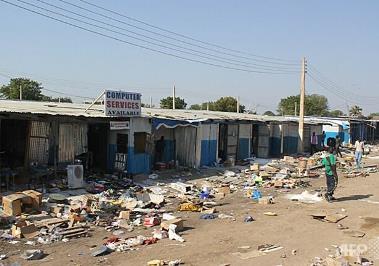 A few men walk through Bor market in South Sudan's Jonglei state, in the aftermath of massive looting carried out by rebel forces. Ongoing fighting has severely disrupted trade and business activities across the country (Photo: AFP/Waakhe Simon Wudu)