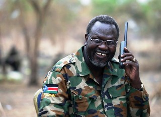 Rebel leader Riek Machar talks on the phone in his field office in a rebel controlled territory in Jonglei State February 1, 2014 (Reuters/Goran Tomasevic)