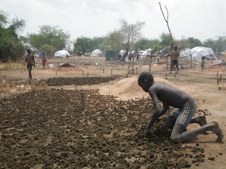 A boy spreading cow dung which is burned in the evening to keep cattle warm and ward off mosquitoes. They have no access to education and have to help their parents by keeping cattle in the Toc are of Bor in South Sudan's troubled Jonglei state. 13 March 2014 (ST)