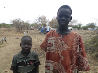 Two boys who spread cow dung which is burned in the evening to keep cattle warm and ward off mosquitoes. They have no access to education and have to help their parents by keeping cattle in the Toc are of Bor in South Sudan's troubled Jonglei state. 13 March 2014 (ST)