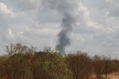 This photo taken from Jebel Kujur in the South Sudan capital, Juba, shows smoke billowing from a military facility in the distance as the sound of explosions were heard across the city on 5 March 2014 (Photo: WFP/George Fominyen)
