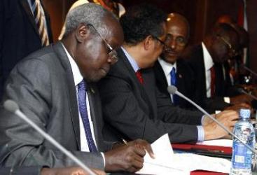 The leader of South Sudan’s government delegation, Nhial Deng Nhial (L), signs a ceasefire agreement aimed at ending conflict in the country following negotiations in the Ethiopian capital, Addis Ababa, on 23 January 2014 (Photo: Reuters/Birahnu Sebsibe)