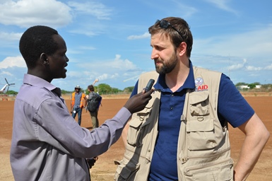 USAID's Jeremy Konyndyk speaks to journalist Jacob Achiek in Bor, the capital of South Sudan's Jonglei state, during a visit to the region (ST)