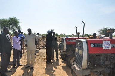 Jonglei state's minister of agriculture, Mayen Ngor, showing officials the tractors recovered in the capital, Bor, on 11 April 2014 (ST)