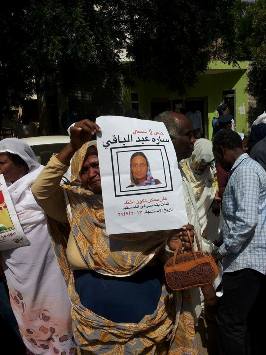 Woman holding a poster of Sara Abdel-Bagi in front of court in Khartoum May 28, 2014 (ST)