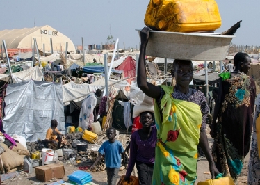 A woman carries water through a UN camp for internally displaced people in South Sudan's Upper Nile state (Photo: IOM)