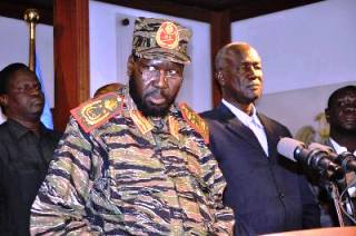 South Sudan's president, Salva Kiir, who rarely appears in military fatigues, addresses the nation in December 16, 2013 (Reuters)