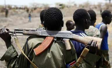A South Sudanese army (SPLA) soldier holds his rifle near an oil field in Unity state on 22 April 2012 (AP)