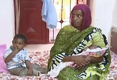 Meriam Yehya Ibrahim pictured inside Omdurman's Women's Prison with her two children, Martin (L) and newborn baby daughter, Maya