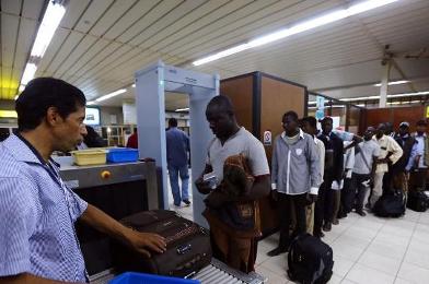 African travellers pass through security checks at Tripoli's Mitiga airport on 22 July 2014 after clashes between rival militias closed down Tripoli International Airport (Photo: AFP/Mahmud Turkia)