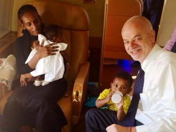 Meriam Ibrahim, pictured with her children and Italy's deputy foreign affairs minister, Lapo Pistelli, on an Italian government plane en route to Rome on 24 July 2014 (Photo from Facebook)