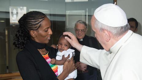 In this photo provided by the Vatican newspaper L'Osservatore Romano, Sudan’s Meriam Ibrahim, holding her daughter Maya in her arms, is shown meeting Pope Francis in Rome on 24 July 2014