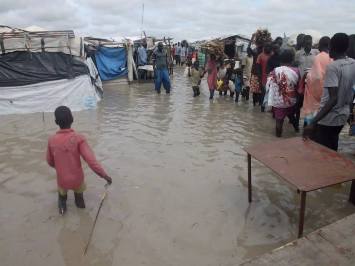 Residents at a camp for internally displaced people in Unity state's Rubkotna wade through flood waters (Facebook photo)
