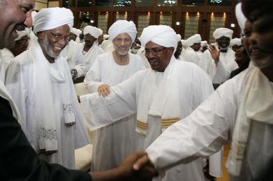 Sudanese president Omer al-Bashir (C-R) greets supporters while Hassan al-Turabi (L) smiles and Ghazi Salah Al-Deen Attabani stands besides him after his speech calling for national dialogue on 27 January 2014 (Photo: AFP/Ebrahim Hamid)