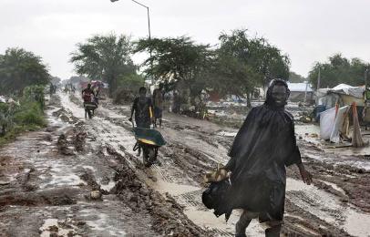 Internally displaced people make their way along the main thoroughfare at a UN camp in Upper Nile state capital Malakal during the wet season (Photo: AP/Matthew Abbott)