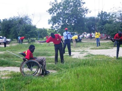 Members of the red army and their chairman, Daniel Deng, (pictured in wheel chair) during the cleaning exercise in Jonglei state capital Bor on 10 August 2014 (ST)