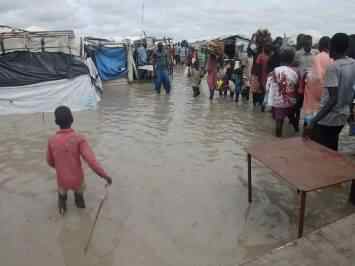 Residents at a camp for internally displaced people in Unity state’s Rubkotna wade through flood waters (Facebook photo)