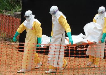 Doctors without Borders staff remove an Ebola victim at a treatment centre in Guekedou, Guinea, in April (Photo: Seyllou/AFP/Getty Images)