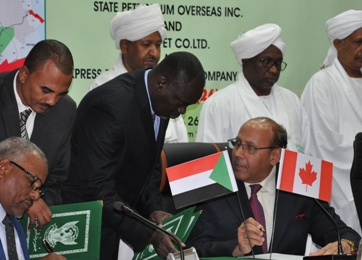 A representative from the State Oil Company Canada Ltd signs the exploration and production sharing agreement  in Khartoum on Sunday, while vice-president Hasabo Abdel Rahma and investment minister Mustafa Osman Ismail look on (Photo courtesy of the ministry of petroleum)