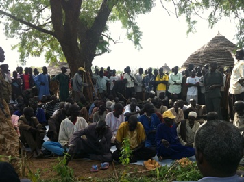 Mourners gather at the grave of the late Yol Muordit Dhel in his home village of Acholapuk in South Sudan's Warrap state following the senior army officer's murder in Lakes state (ST)