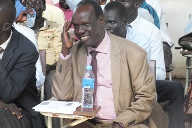 Deputy vice-chancellor for administration Professor Robert M.K. Deng smiles as he watches the Jonglei’s episcopal church choir perform at the Dr John Garang Memorial University of Science and Technology on 22 September 2014 (ST)