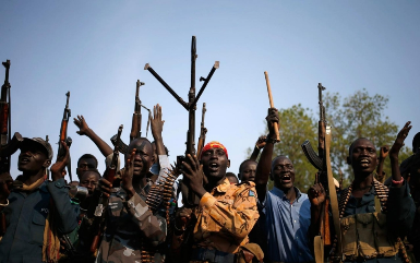 Rebel fighters aligned with former vice-president Riek Machar gather in a village in South Sudan's Upper Nile state on 8 February 2014 (Photo: Goran Tomasevic/Reuters)