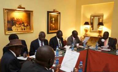 Negotiators at South Sudan peace talks in the Ethiopian capital, Addis Ababa, review a draft of a cessation of hostilities agreement signed between rebel and government forces on 13 January 2014 (Photo: Larco Lomayat)