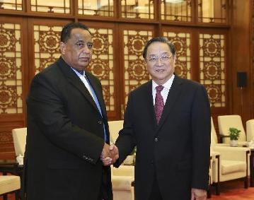 Yu Zhengsheng (R), chairman of the National Committee of the Chinese People's Political Consultative Conference, meets with the deputy chairman of Sudan's ruling National Congress Party (NCP), Ibrahim Ghandour, in the Chinese capital, Beijing, on 28 January 2015 (Photo: Xinhua/Ding Lin)