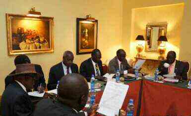 Negotiators at South Sudan peace talks in the Ethiopian capital, Addis Ababa, review a draft cessation of hostilities agreement on 13 January 2014 (Photo courtesy of Larco Lomayat)