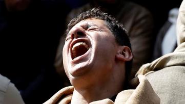 A man mourns over Egyptian Coptic Christians who were captured in Libya and killed by militants affiliated with the Islamic State group, inside the Virgin Mary Church in the village of el-Aour, near Minya, 220 kilometers (135 miles) south of Cairo, Egypt, Monday, Feb. 16, 2015 (AP Photo/Hassan Ammar)