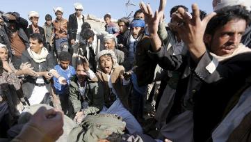 People react as they search for survivors under the rubble of houses destroyed by an air strike near Sanaa Airport March 26, 2015. (REUTERS/Khaled Abdullah)