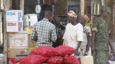 A trader sells items to customers in Bor town March 26, 2015 (ST)