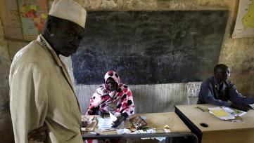 A man waits to check for his name at an official at a polling station on the third day of elections in Khartoum on 15 April 2015 (Photo: Reuters/Mohamed Nureldin Abdallah)