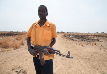 Biar Mabior Dau stands on a village road leading into bushland where he takes care of his cattle on 12 March 2015 (ST)