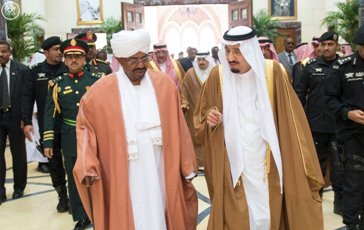 Sudanese president Omer Hassan al-Bashir (L) walking with Saudi Arabia’s King Salman Bin Abdel Aziz in Riyadh on 25 March 2015 (SPA)