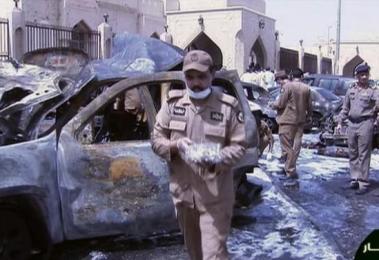 In this still image taken from video provided by Saudi TV, burnt out cars are seen as investigators collect evidence, in the aftermath of a suicide bomb outside the the Imam Hussein mosque in the port city of Dammam, Saudi Arabia, Friday, May 29, 2015.(AP)