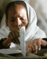 An Ethiopian woman casts her vote at a polling station in Addis Ababa, on Sunday, May 15, 2005 (AP Photo)
