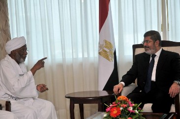 FILE - Egyptian President Mohammed Morsi (R) meets with Hassan al-Turabi, Sudan's Islamist opposition leader, in Khartoum on April 5, 2013 )EBRAHIM HAMID/AFP/Getty Images)