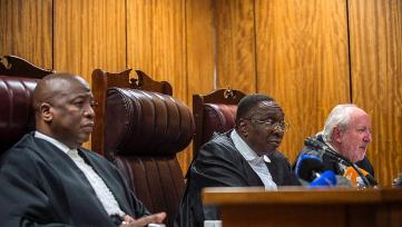 South African judges (left to right) Aubery Ludnaba, Dusian Nkawba and Hans Frabricius hear the case against Sudanese President Omer al-Bashir at the North Gauteng High Court in Pretoria, on June 15, 2015 (AFP Photo/Mujahid Safodien)